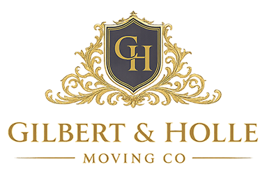 Logo of Gilbert and Holle Moving Company featuring a decorative shield design and elegant typography emphasizing quality moving services.